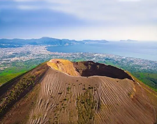 Aerial view into the crater of Mount Vesuvius, with the Bay of Naples and the coast beyond