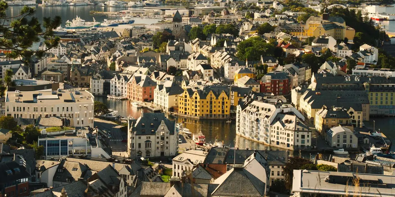 Ålesund's Art Nouveau rooftops and harbour seen from above in warm evening light