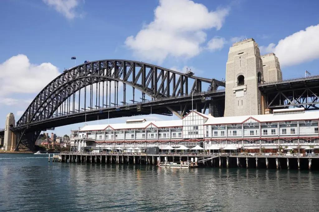 Pier One Sydney Harbour, a long white timber wharf building over the water at Walsh Bay, right beside the Sydney Harbour Bridge