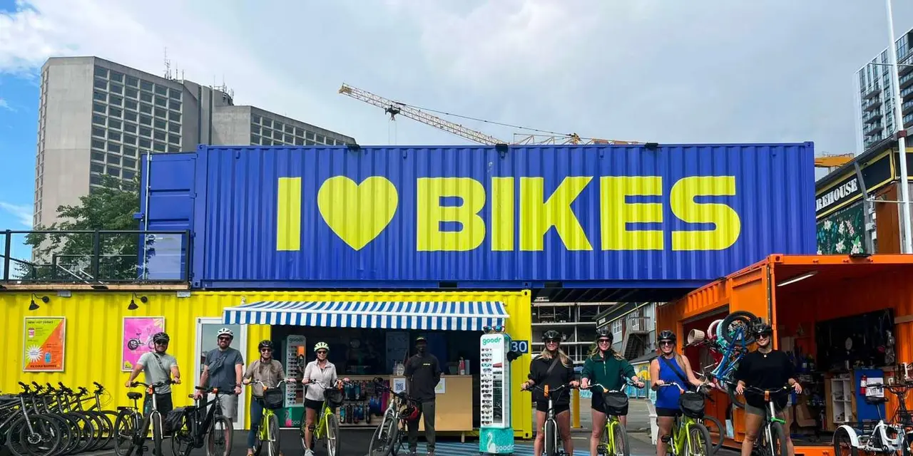 The bright 'I love bikes' shop container with a row of e-bikes outside