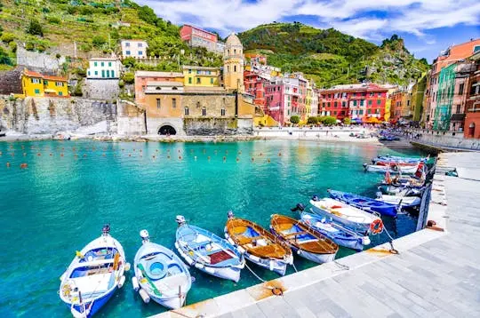 Vernazza's harbour with blue-and-white boats and its church tower