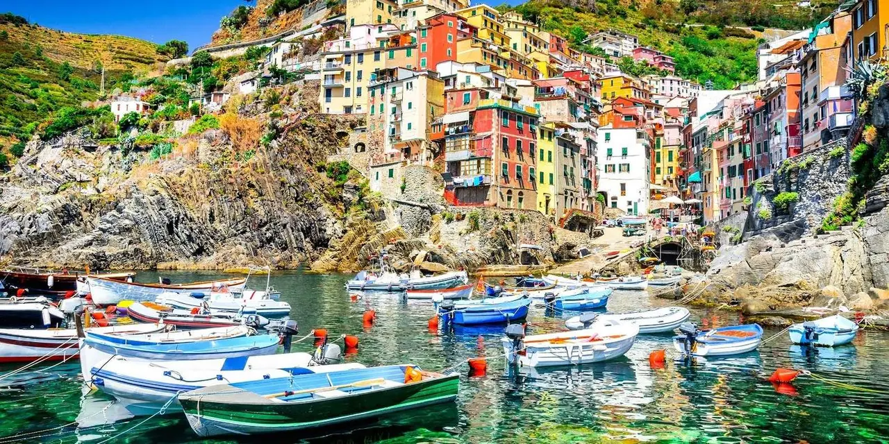 Riomaggiore's colourful houses stacked above its small harbour full of boats
