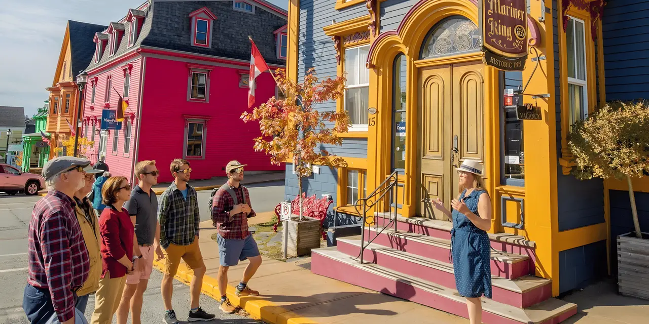 A tour group on a Lunenburg street lined with brightly painted wooden buildings