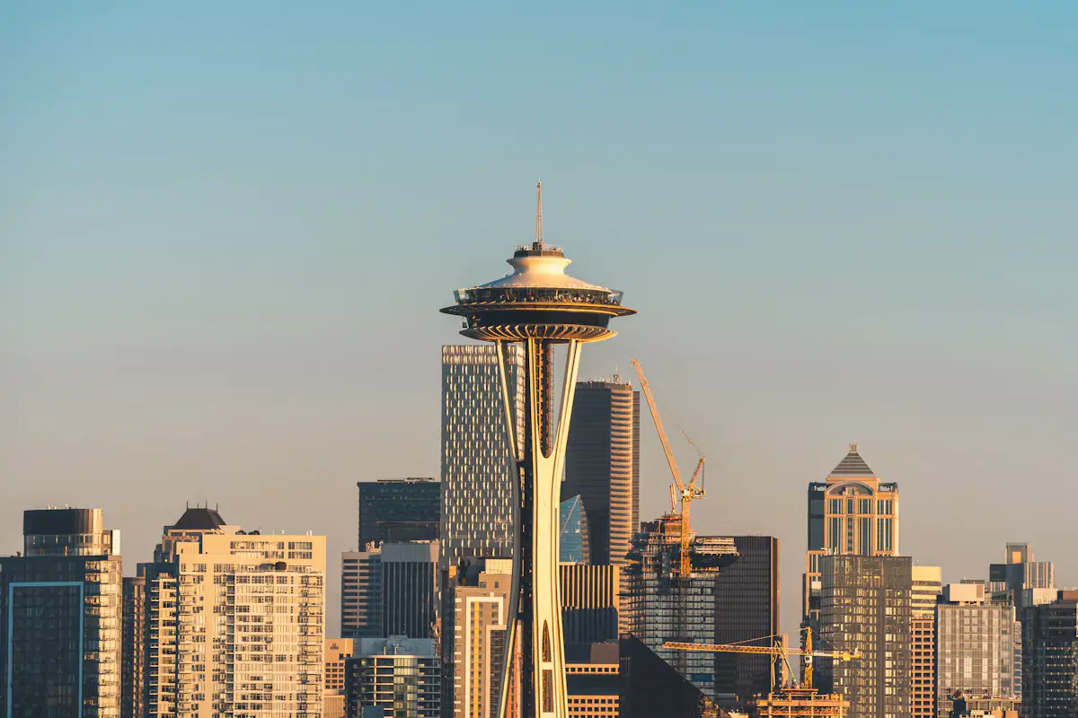 The Space Needle rising above the downtown Seattle skyline in warm evening light, seen from Kerry Park