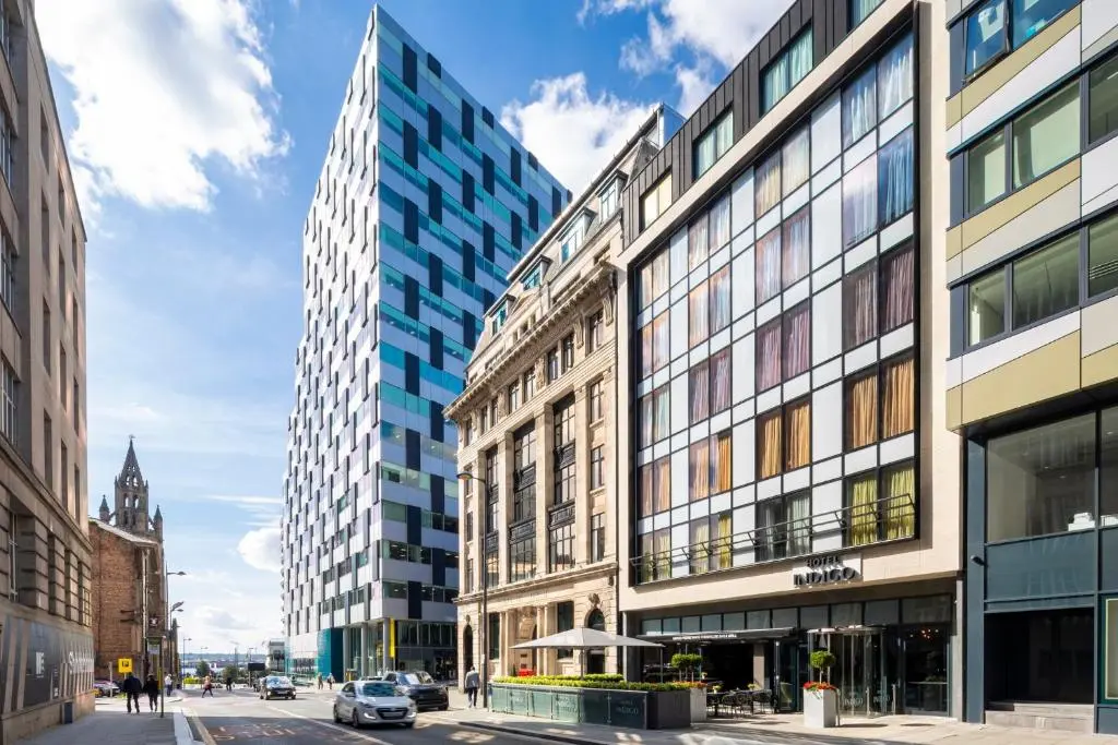 Chapel Street in Liverpool on a sunny day, with Hotel Indigo's entrance at street level among modern glass office blocks