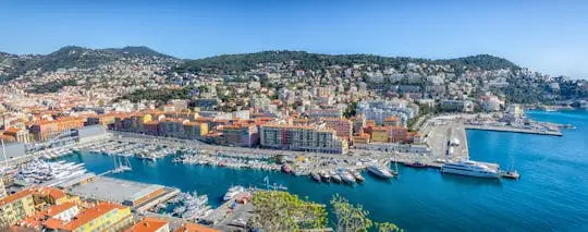 Panorama of Nice's Port Lympia harbour with the city climbing the hills behind