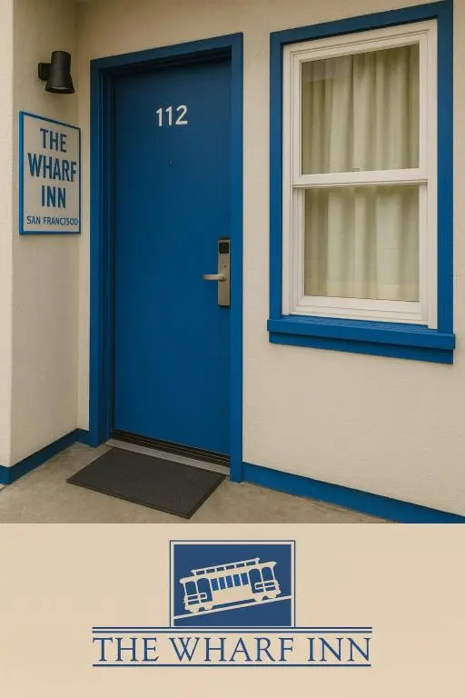 A blue guest-room door numbered 112 beside The Wharf Inn's cable-car logo sign