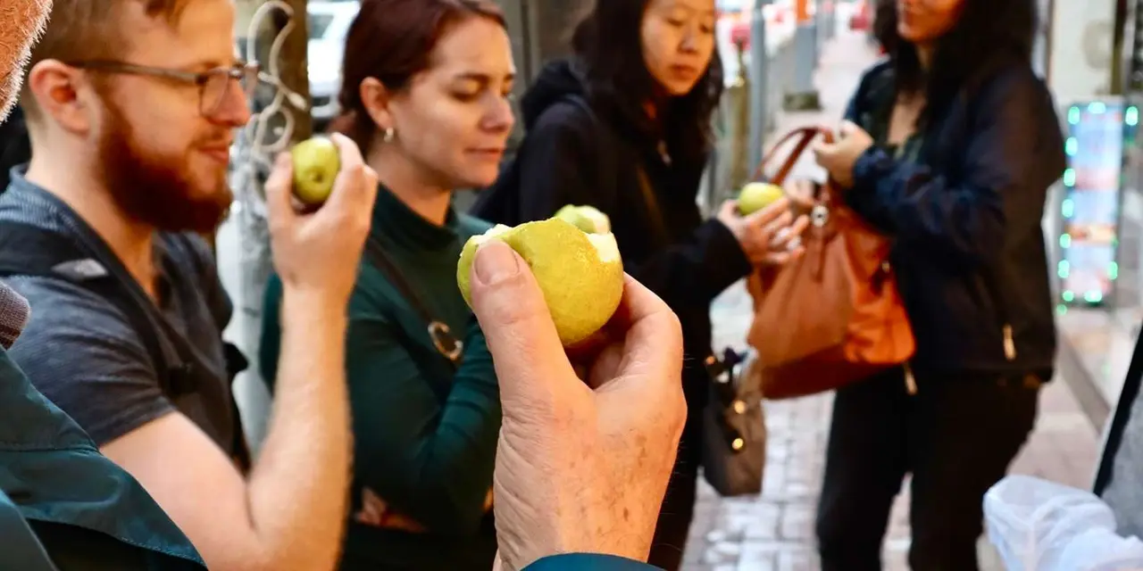 Visitors tasting pineapple buns on a Hong Kong street