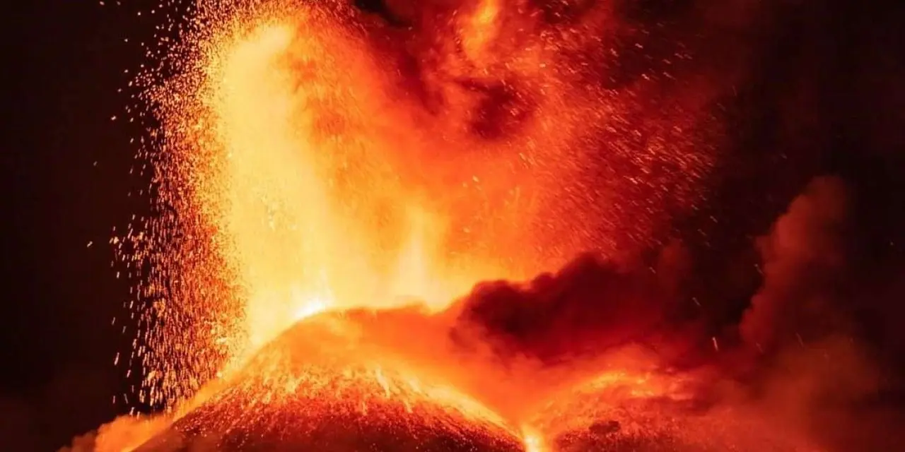 Bright orange lava erupting from Mount Etna at night