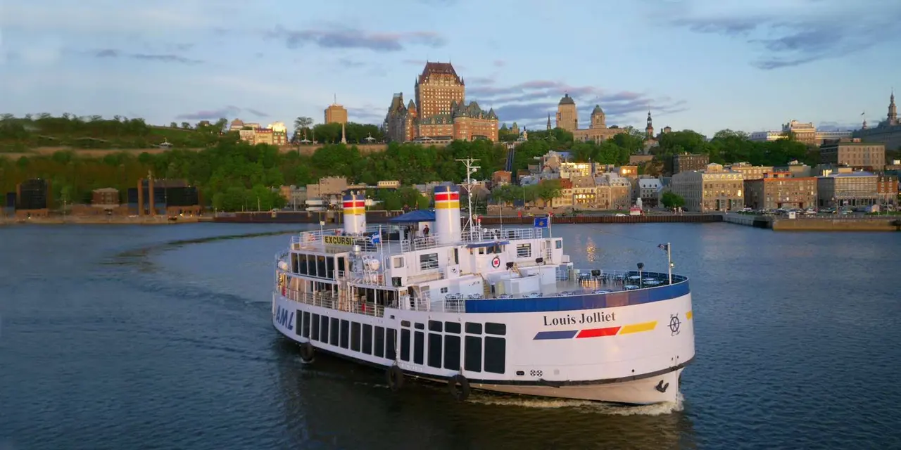 The white Louis-Jolliet cruise boat on the St. Lawrence with the Château Frontenac and Old Québec behind