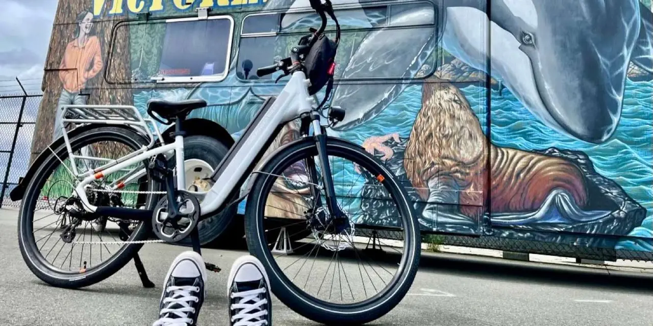 Two bicycles parked in front of a large 'Welcome to Victoria' mural