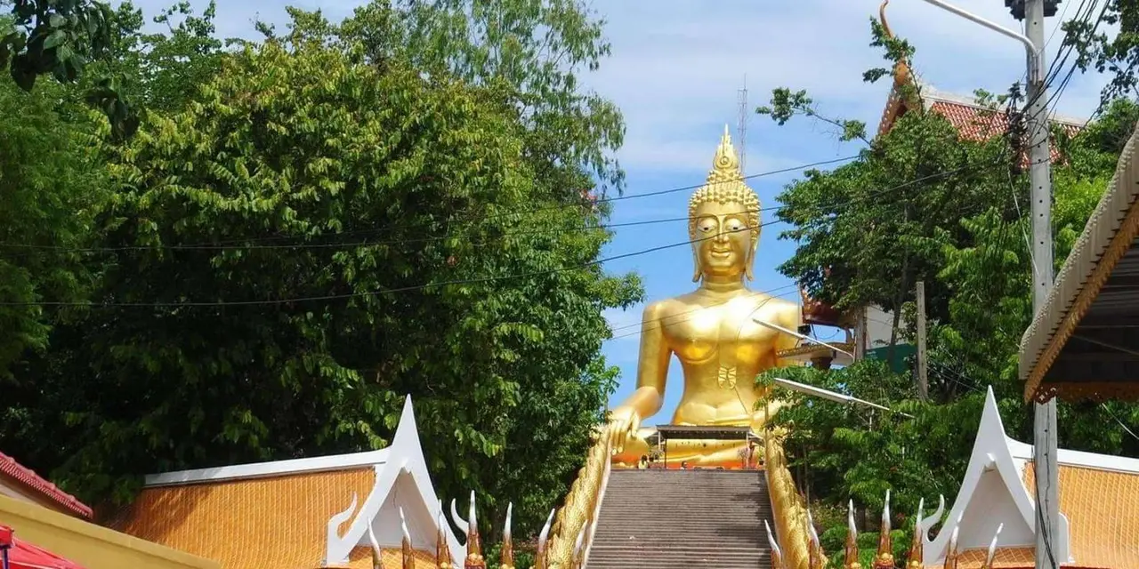 The golden Big Buddha of Pattaya at the top of a staircase lined with dragon balustrades
