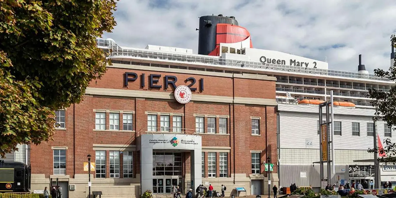 The brick Pier 21 building with the Queen Mary 2 docked behind it