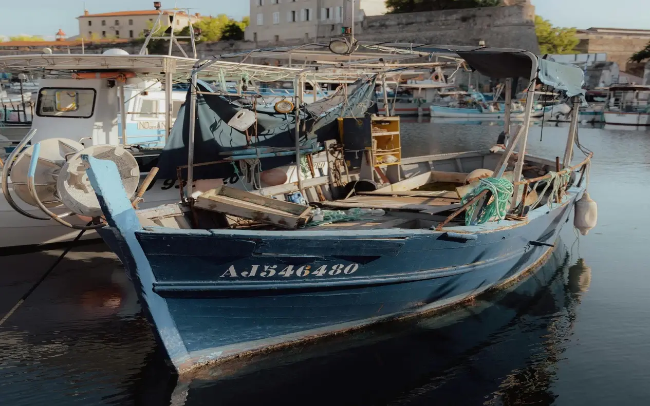 A traditional wooden fishing boat moored in Ajaccio's harbour