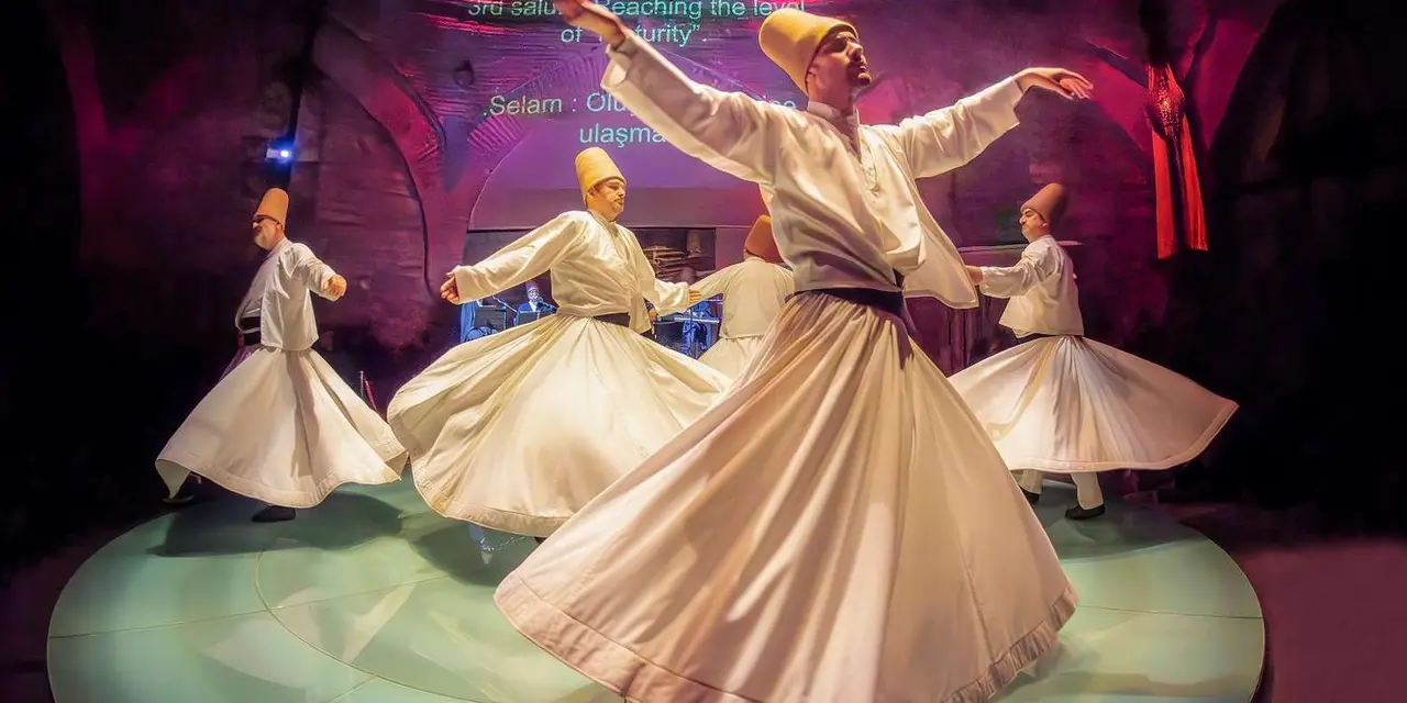 Whirling dervishes in white robes and tall hats spinning on a stage