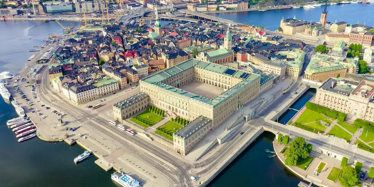 An aerial view of the Royal Palace's courtyard and the surrounding Old Town rooftops beside the water