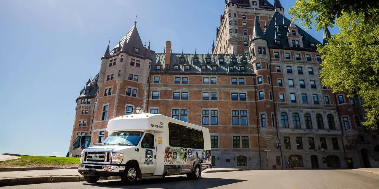 The tour's minibus parked in front of the Château Frontenac on a sunny day