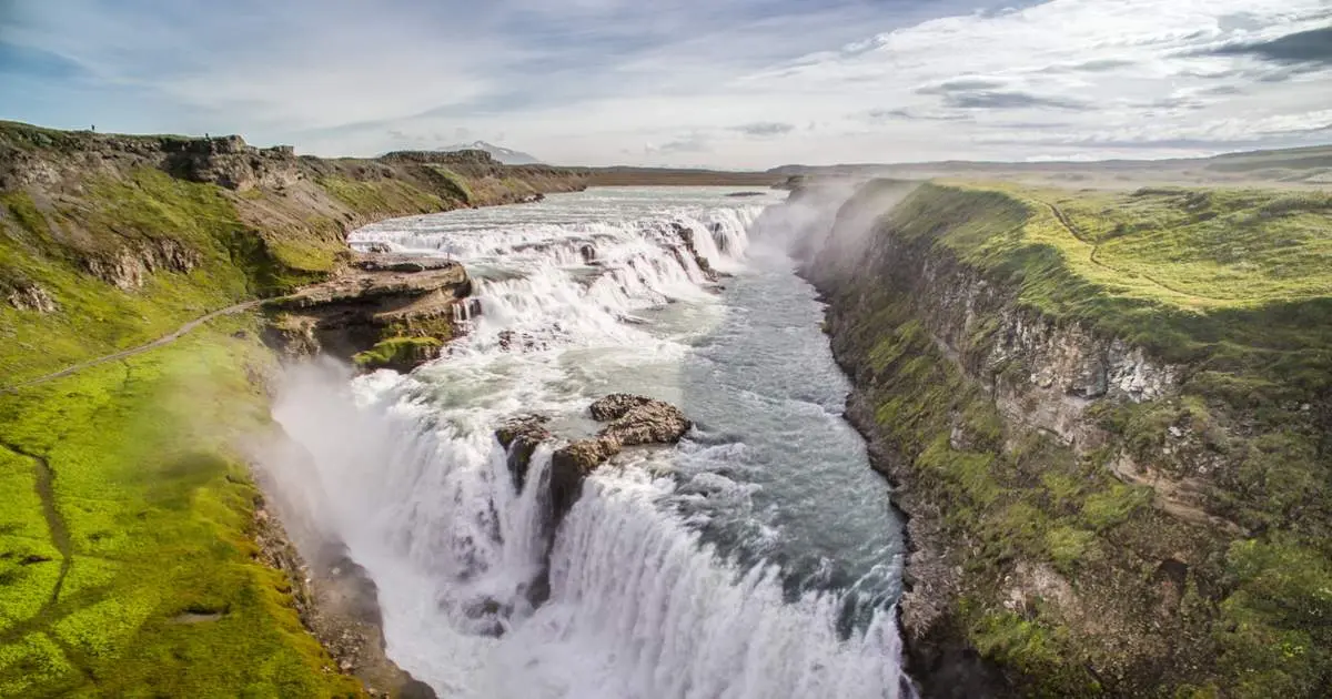 Aerial view of Gullfoss waterfall dropping into a green gorge