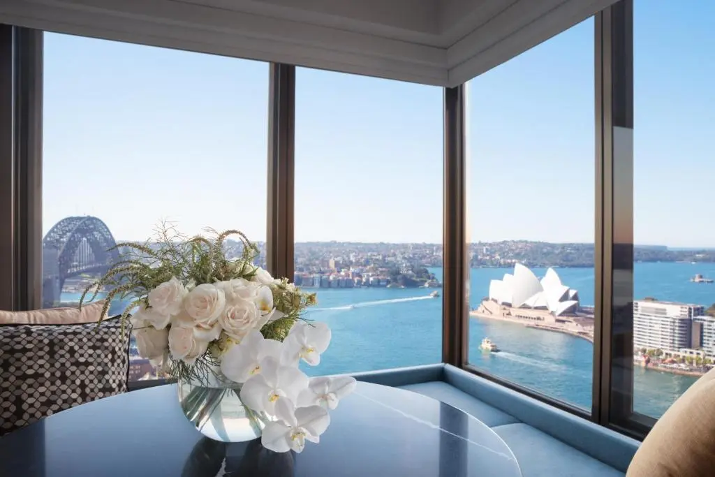 Corner room at Four Seasons Hotel Sydney with floor-to-ceiling windows looking out on the Harbour Bridge and the Sydney Opera House