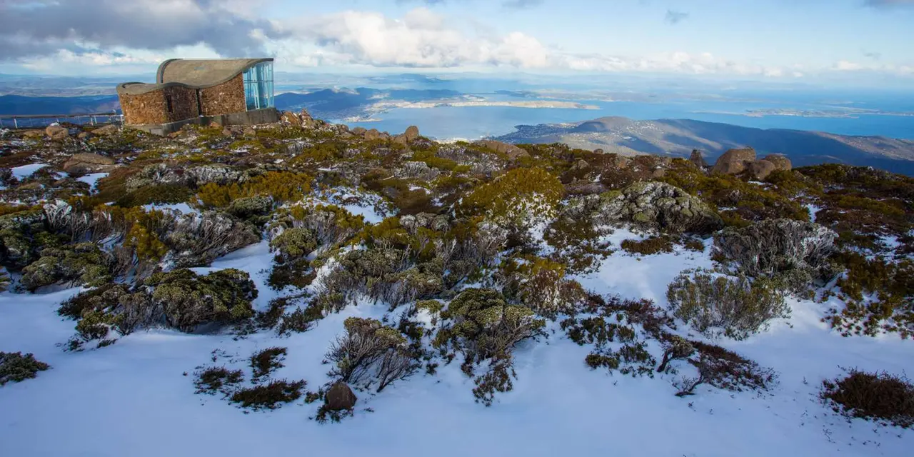 View from the rocky summit of kunanyi over the Derwent estuary and Hobart under a blue sky