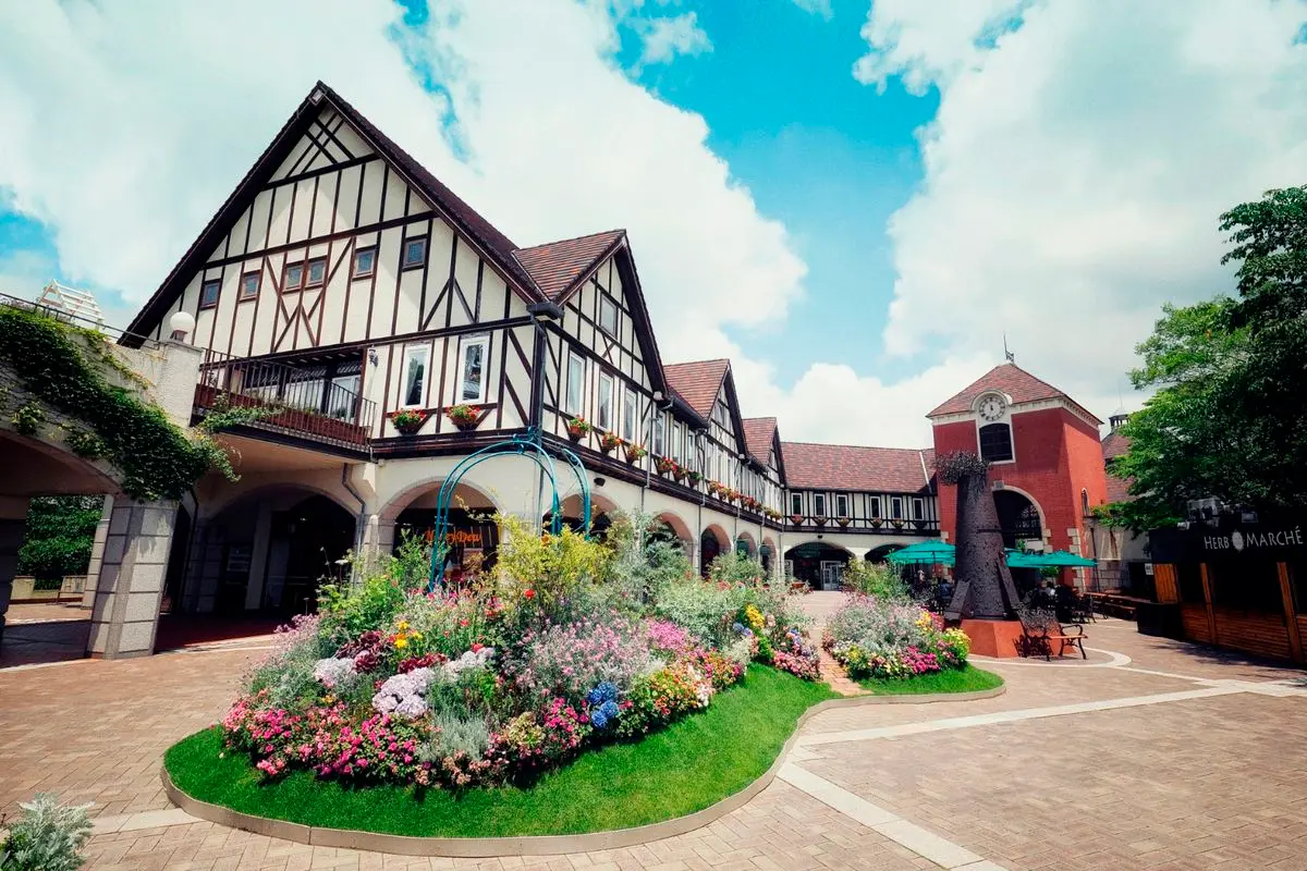 A half-timbered garden house with a bright flowerbed in front at the Nunobiki Herb Gardens