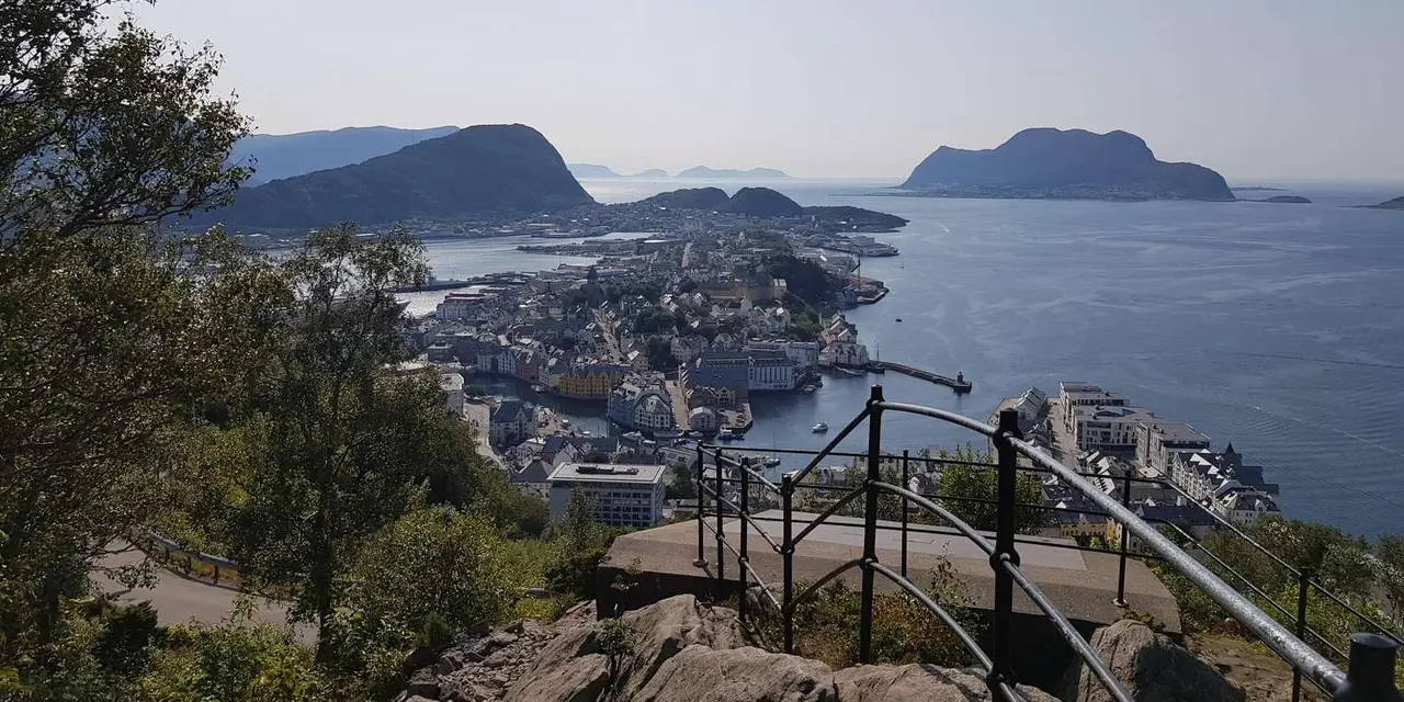Ålesund and its offshore islands seen from a railed hilltop lookout