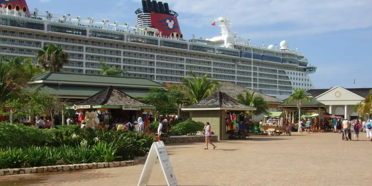 The Falmouth cruise port plaza with a cruise ship moored behind the palm trees