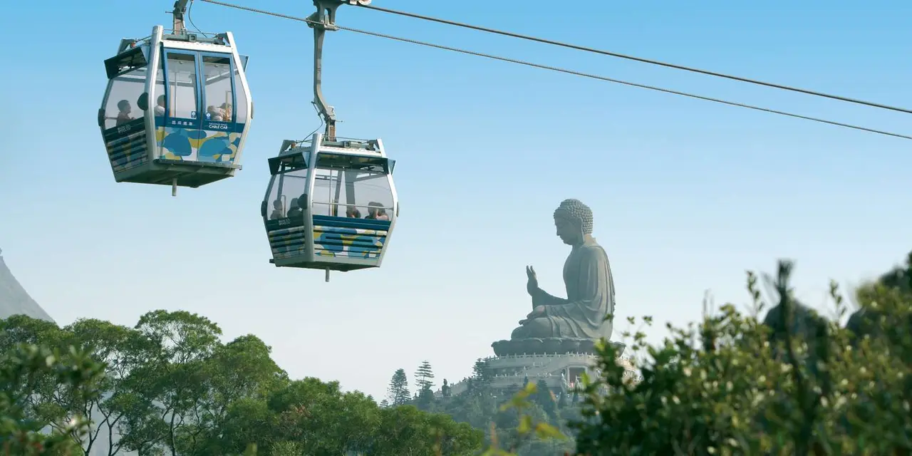 Two cable-car cabins against a blue sky