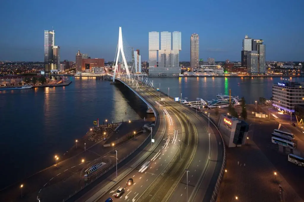 Dusk view across the Nieuwe Maas to the Erasmus Bridge, the De Rotterdam towers and the Rotterdam skyline, as shown on nhow Rotterdam's booking page