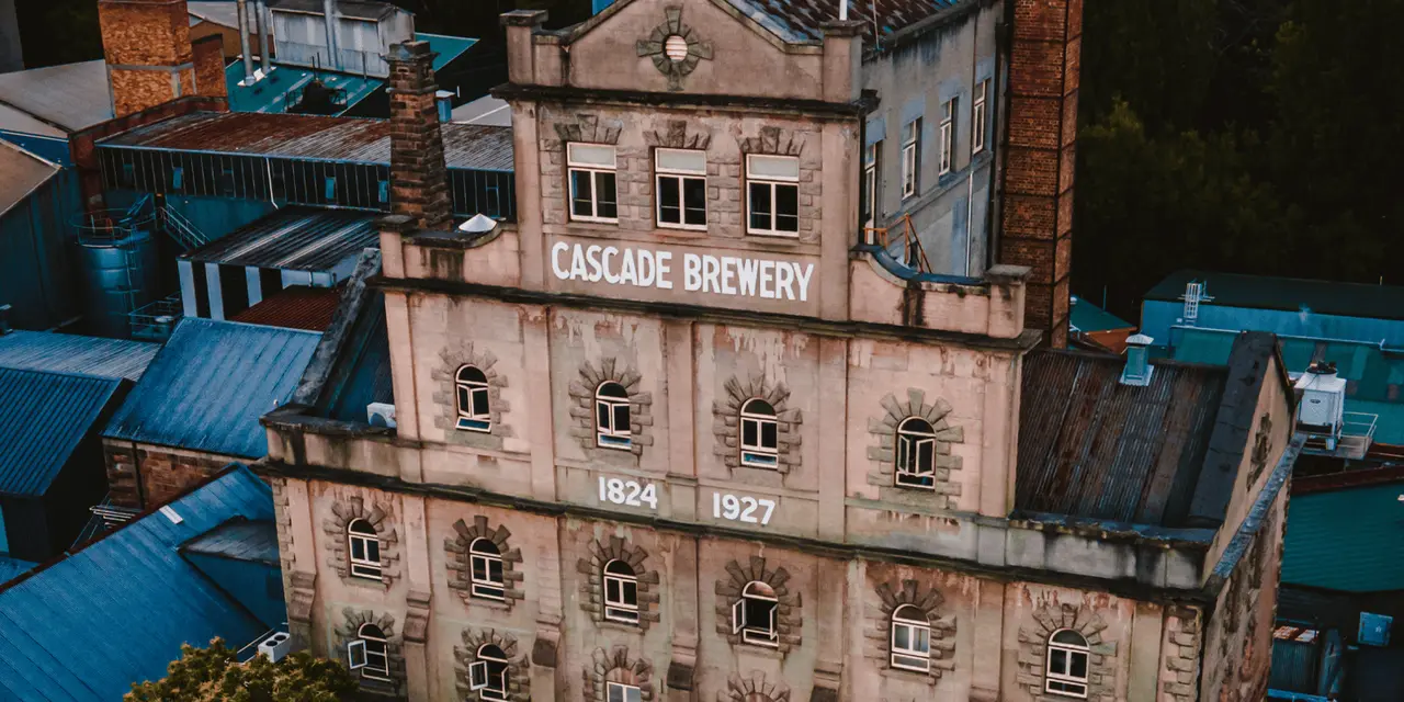 The stone facade of the Cascade Brewery with its name across the top
