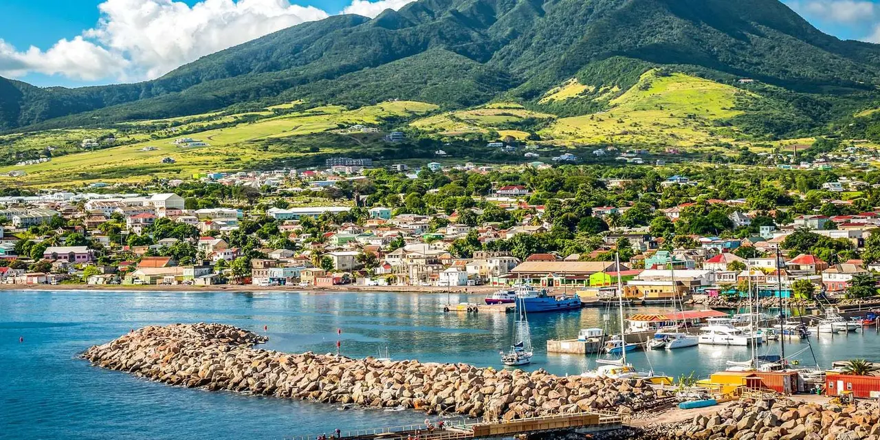 Basseterre's harbor and rock breakwater, with waterfront buildings below green hills