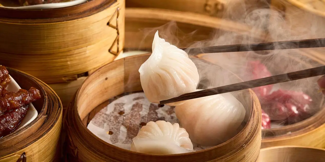 Steaming bamboo baskets of dim sum dumplings