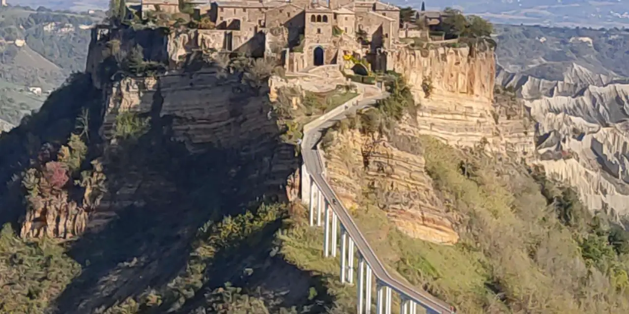 The hilltop village of Civita di Bagnoregio on its eroded cliff, reached by a long footbridge across the valley