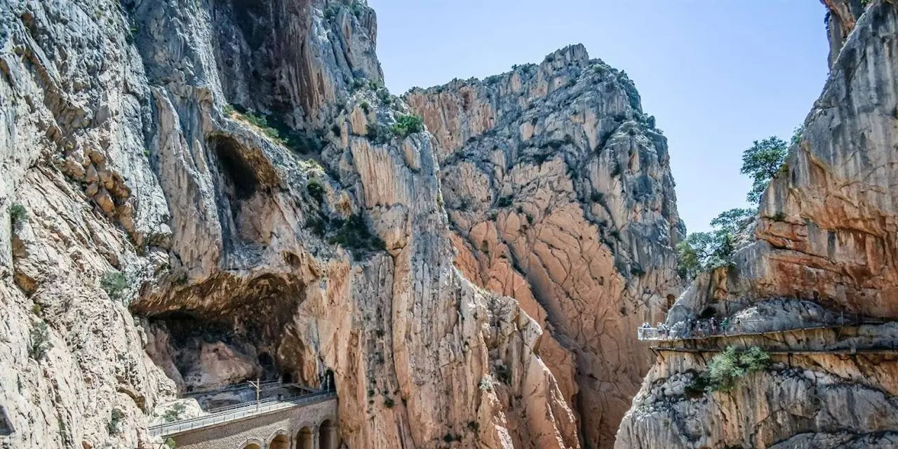 The Caminito del Rey boardwalk pinned along a sheer limestone cliff face